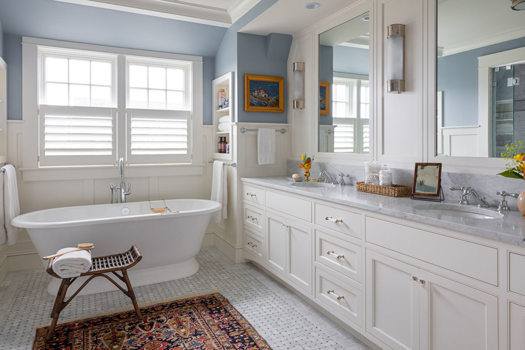 primary bathroom with large tub and double-sink vanity