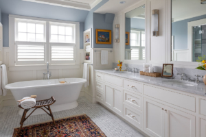primary bathroom with large tub and double-sink vanity