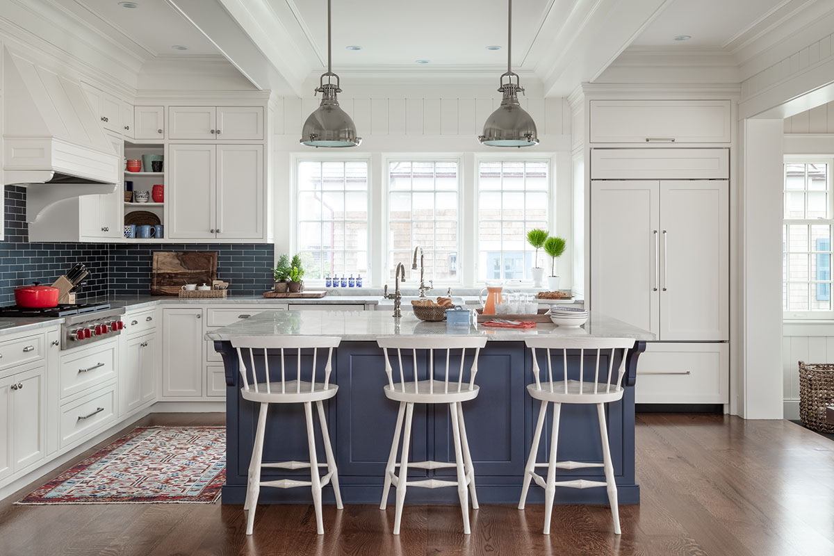 coastal kitchen with pendant lights, large island and counter stools