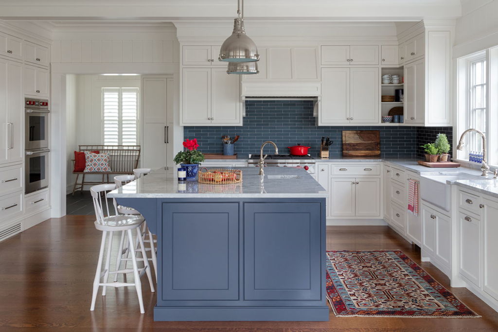 new england inspired kitchen with large island and backsplash
