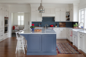 new england inspired kitchen with large island and backsplash