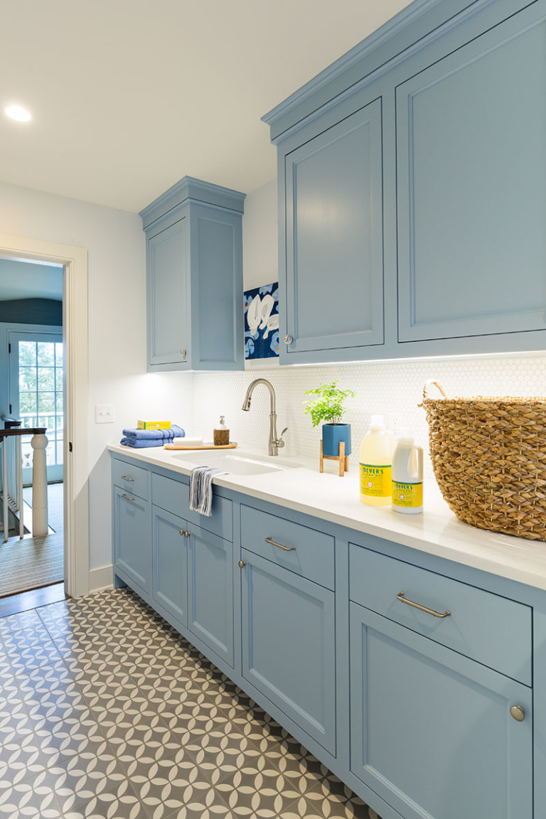 laundry room with colorful cabinetry