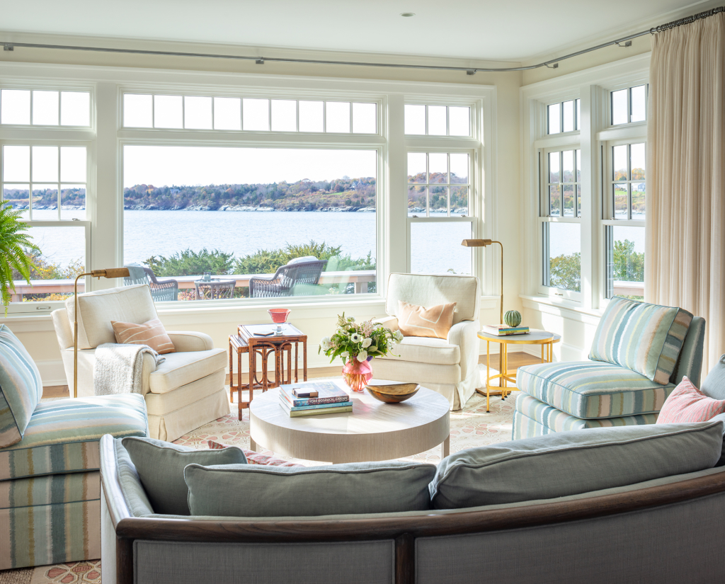 coastal modern living room. Sofa, ottoman and chairs. Ocean views.