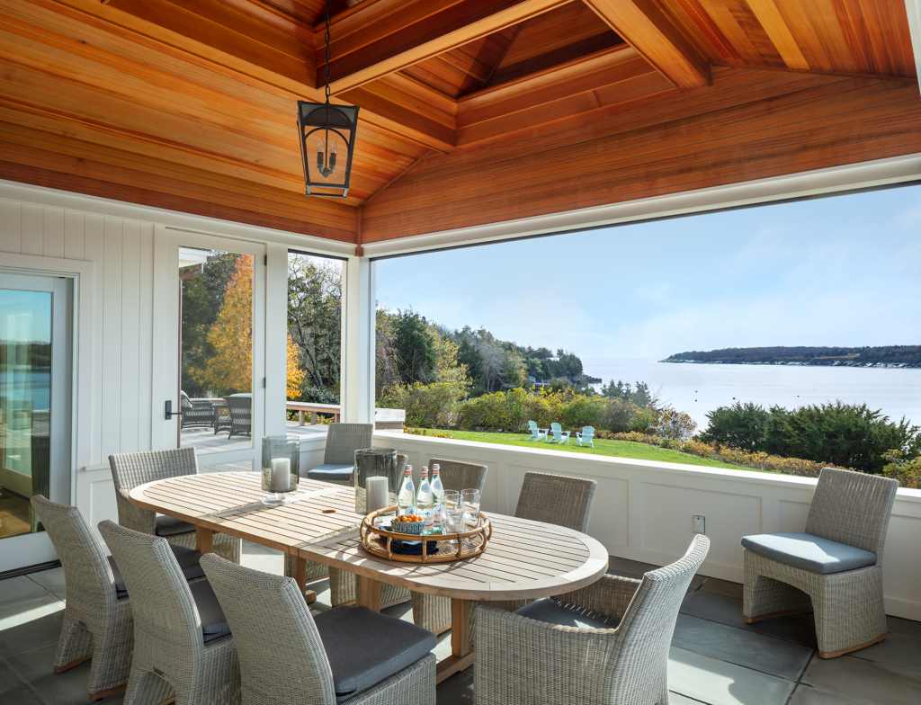 screen porch with outdoor dining table and chairs.