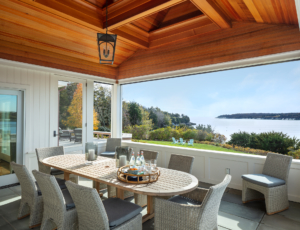 screen porch with outdoor dining table and chairs.