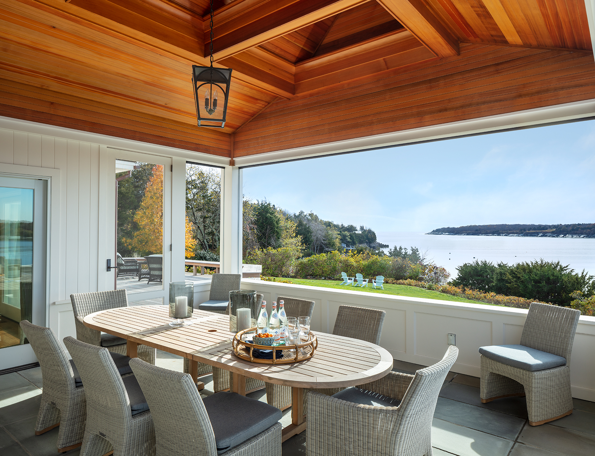 screen porch with outdoor dining table and chairs.