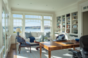 Coastal office with built in shelving, large desk and seating.