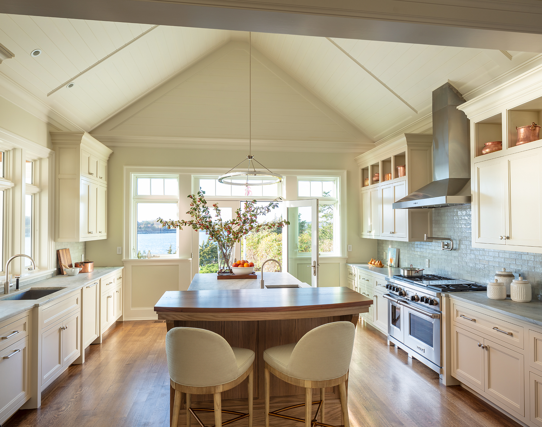 Coastal modern kitchen with large island and vaulted ceilings.