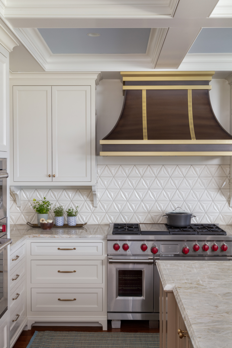 stove range with accent hood and white cabinetry