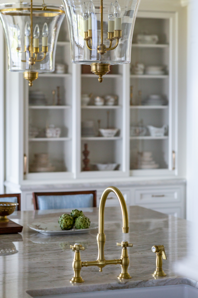 built-in shelving in kitchen with large countertop and lighting
