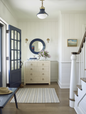 coastal entryway with circle mirror and custom console