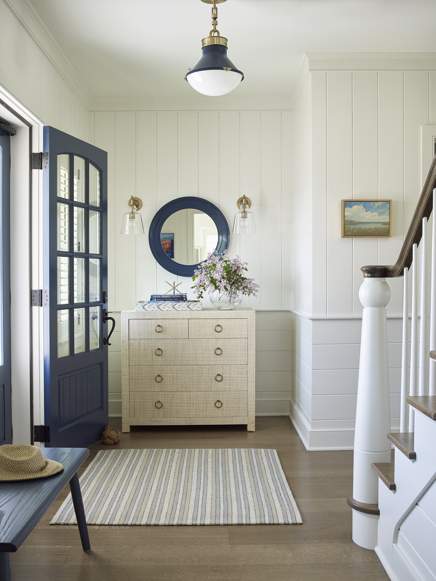 coastal entryway with circle mirror and custom console