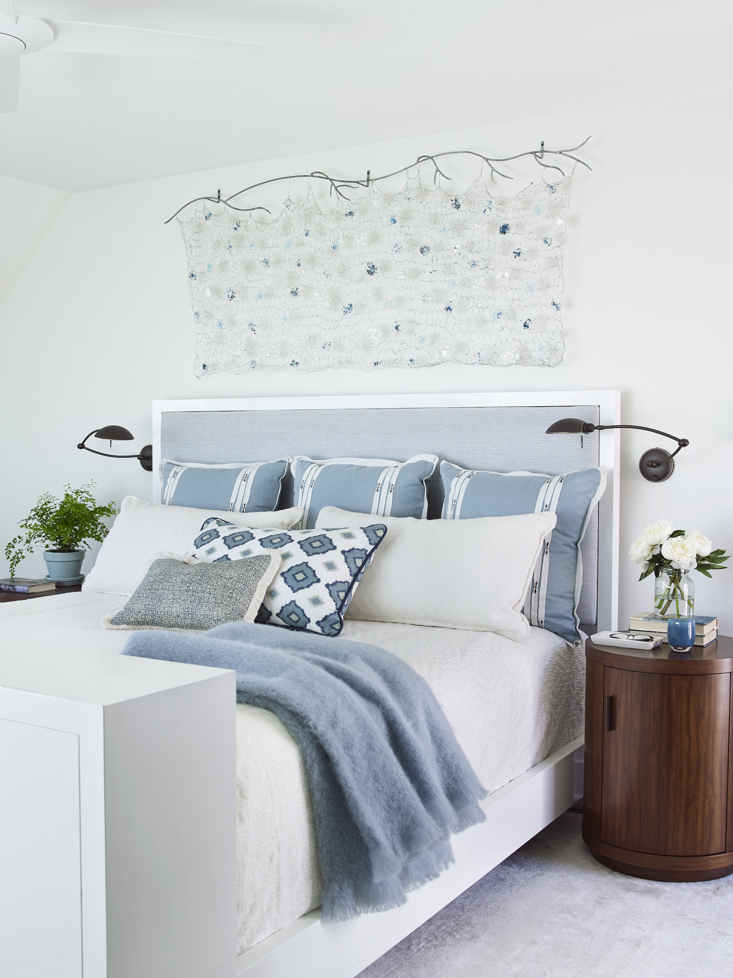 white and blue primary bedroom with original art