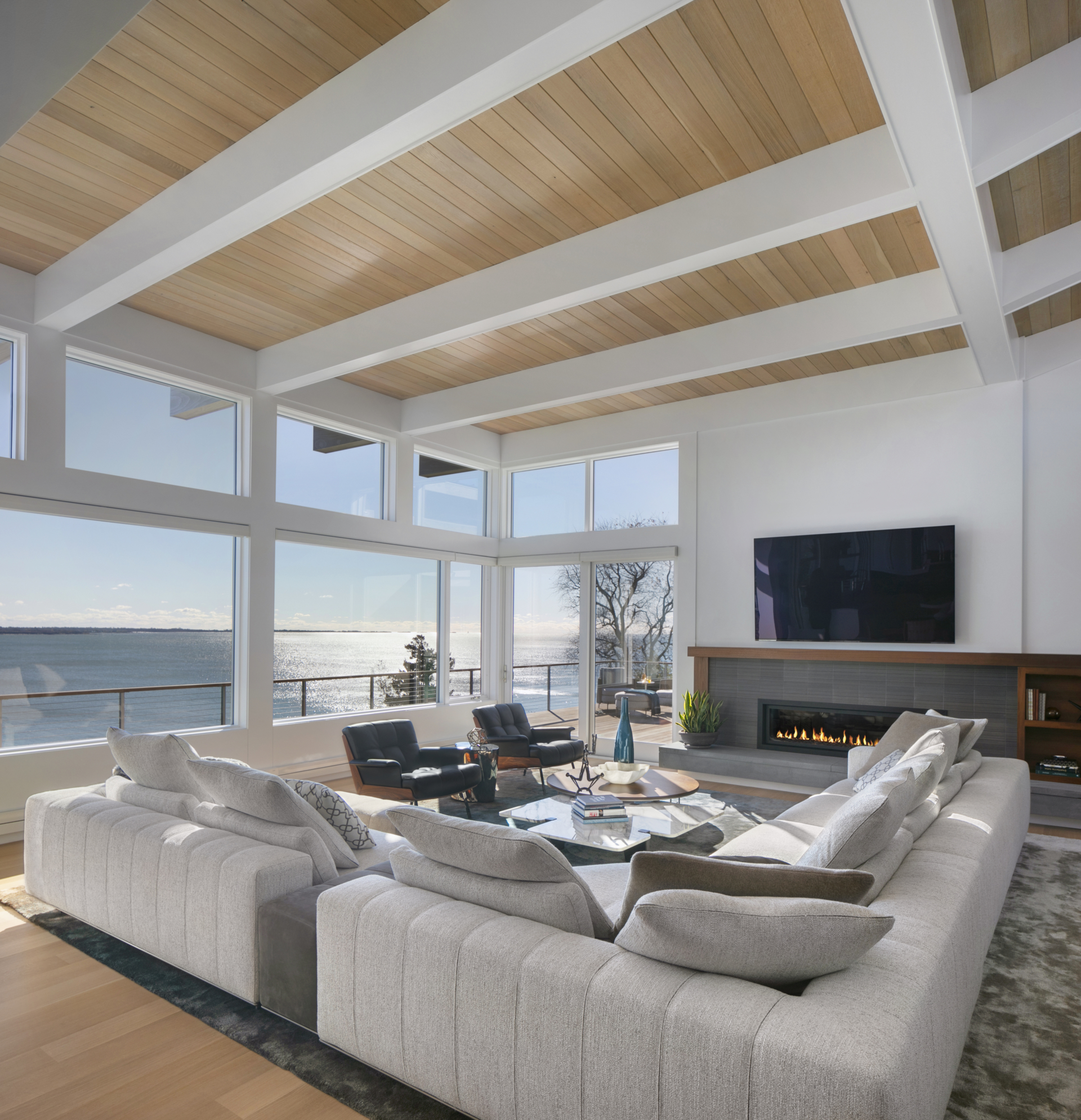 Open-concept living room with fireplace and an ocean view