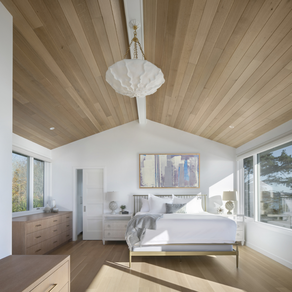 Modern primary bedroom design with original art