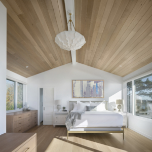 Modern primary bedroom design with original art