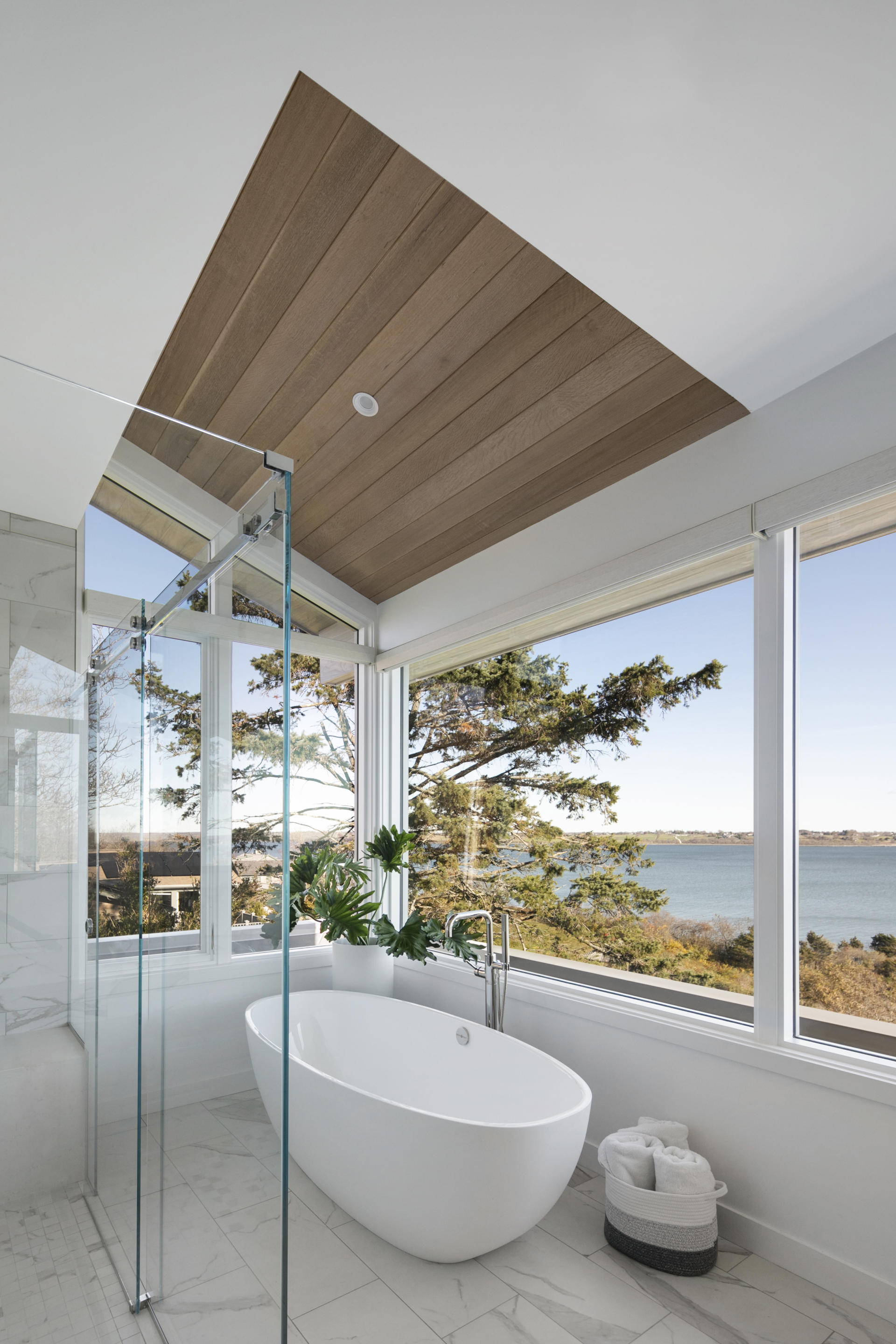 Modern primary bath with soak tub and ocean view