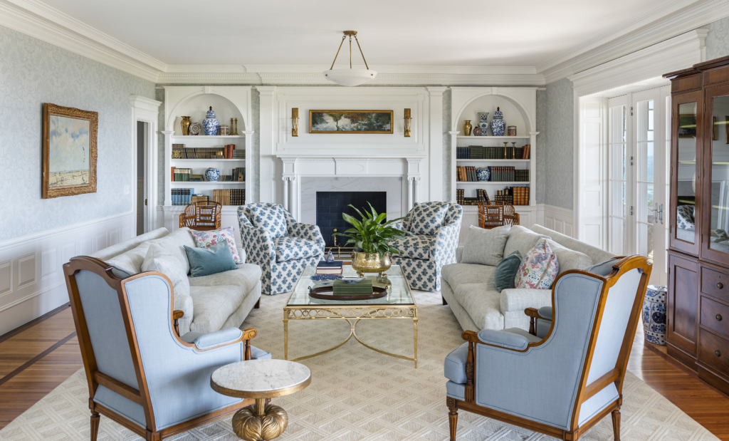 Living room with fireplace and built in bookcases in Stone Lea a historic renovation in Narragansett