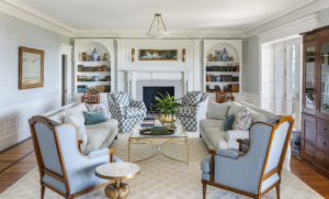 Living room with fireplace and built in bookcases in Stone Lea a historic renovation in Narragansett