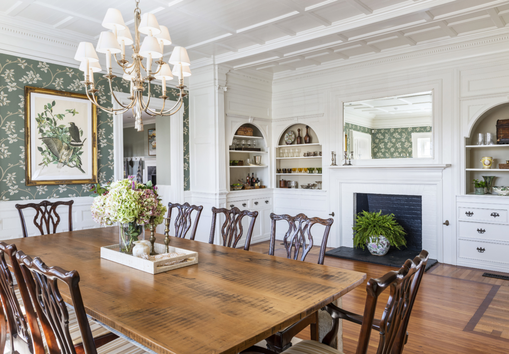 Dining room with wallpaper and fireplace