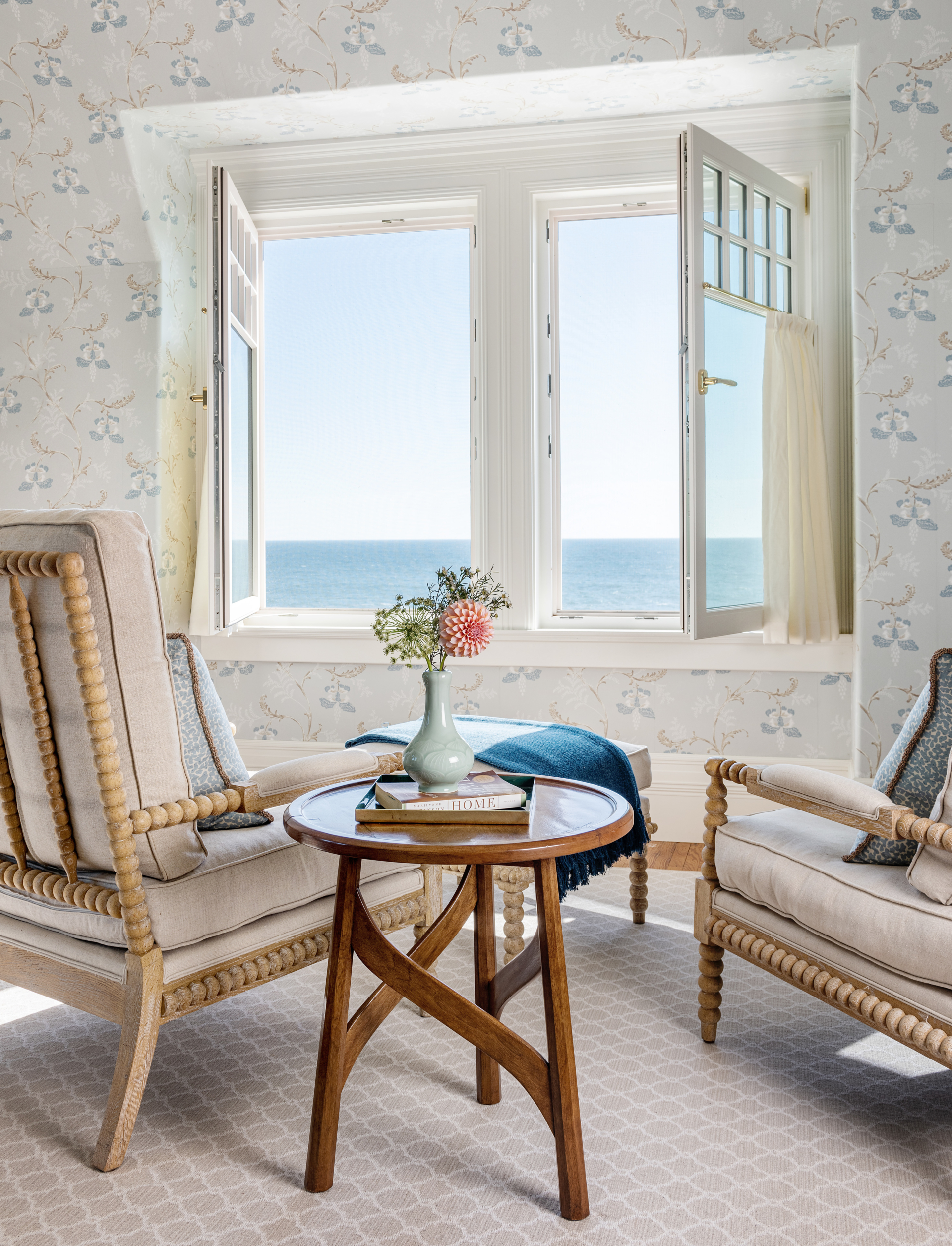 Owner's bedroom seating by window with ocean view