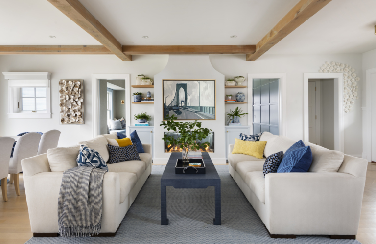 Open-concept great room in a family home. Exposed beams, original art, and luxury custom furniture.