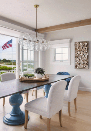 A coastal beach house dining room with a Dunes and Duchess table and flag blowing in the ocean breeze