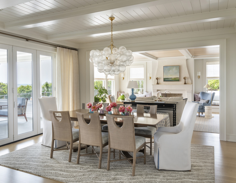 A neutral coastal dining room designed by Taste Design in a modern oceanfront home near Newport RI