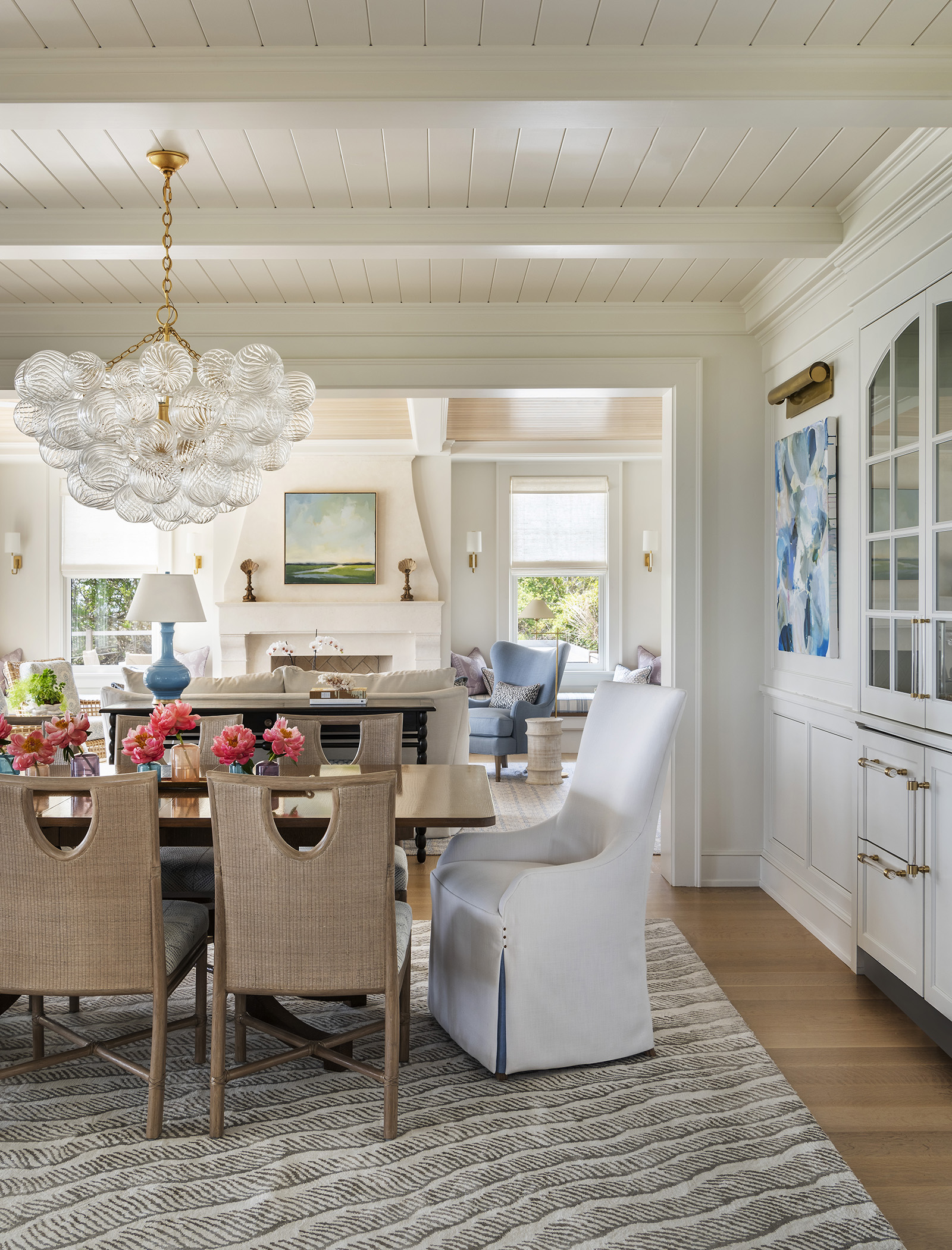 A neutral coastal dining room with built-in cabinetry designed by Taste Design in a modern oceanfront home near Newport RI