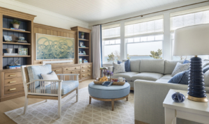 A blue and white family media room with built in oak media center in a coastal home with interior design by Taste Design Inc of Newport RI