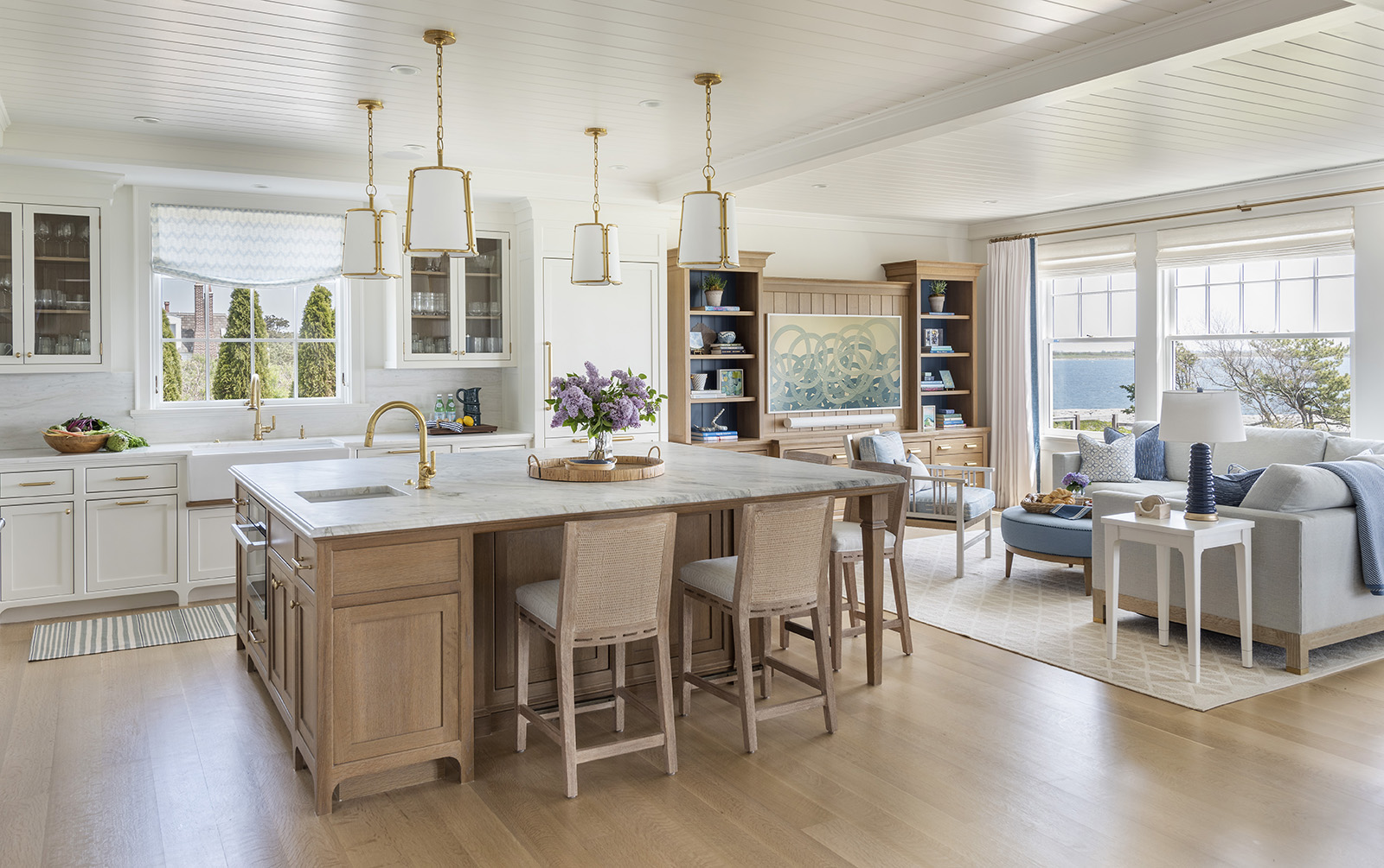 A bright open concept kitchen designed by Taste Design in a modern coastal home near Newport RI