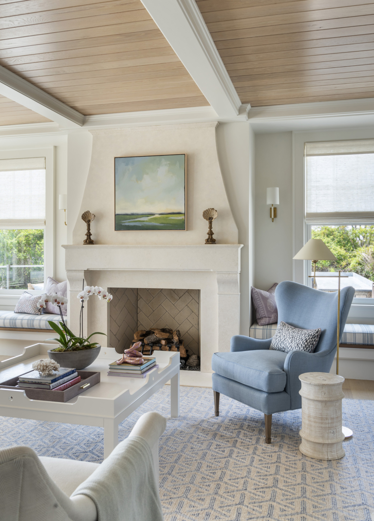 A blue and white living room with an oak panel ceiling designed by Taste Design in a modern coastal Paul Weber home near Newport RI