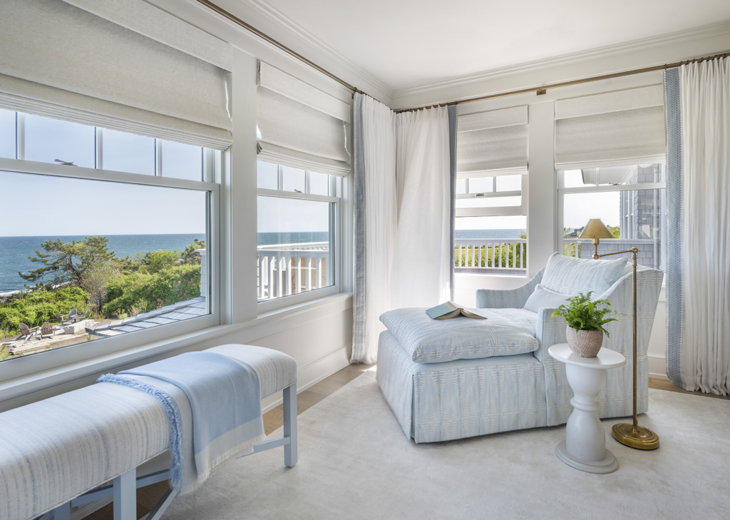 Owner's bedroom with settee overlooking the ocean view in a modern coastal home designed by Taste Design Inc and Paul Weber Architecture near Newport RI