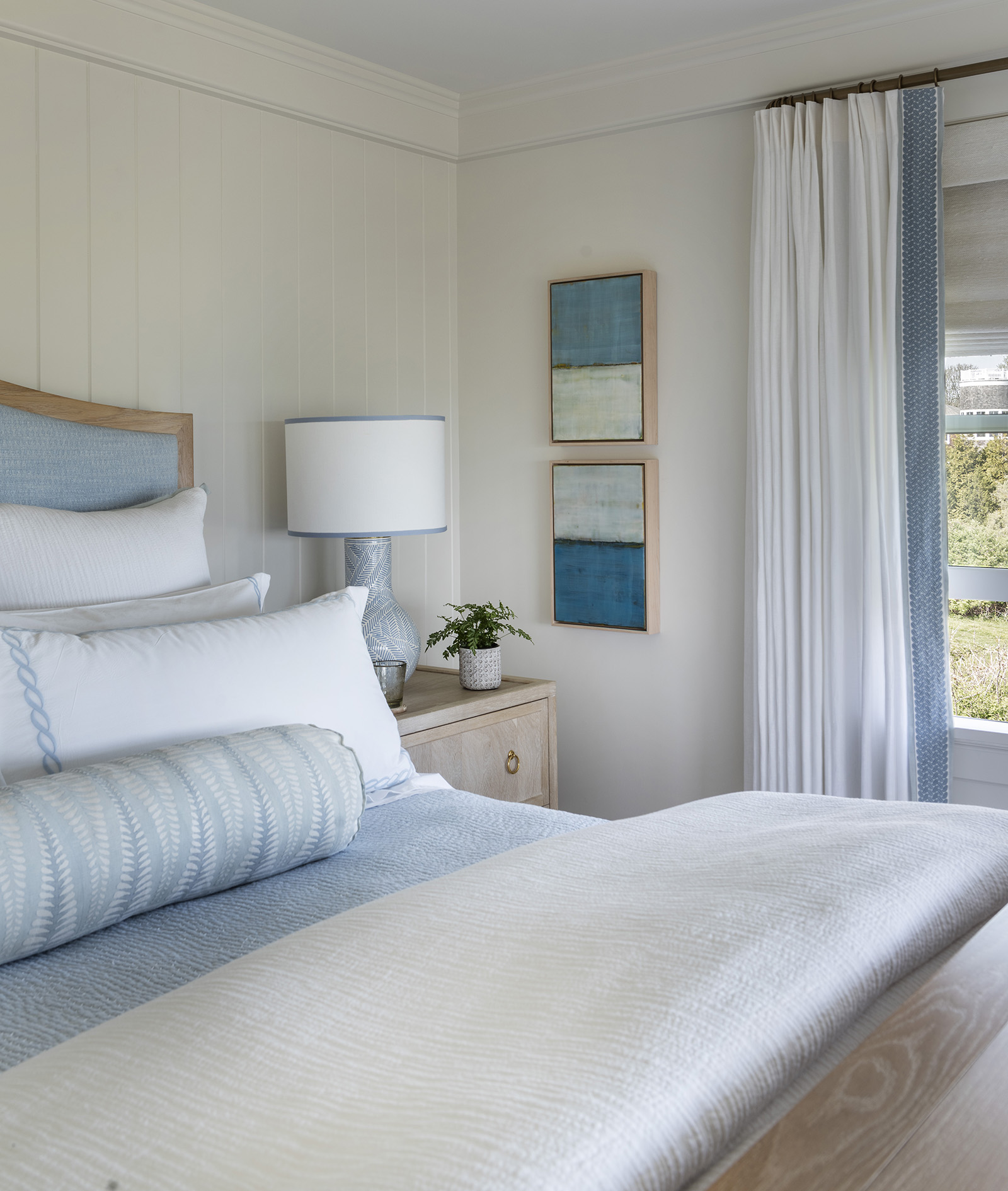Owner's blue and white bedroom in a modern coastal home designed by Taste Design Inc and Paul Weber Architecture near Newport RI