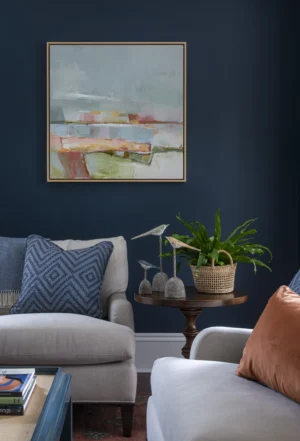 Living room with dark blue walls renovated by Taste Design and original art by Alyn Carlson