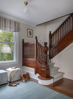 Entryway to a historic renovation project in Newport with an antique stair rail and newel post