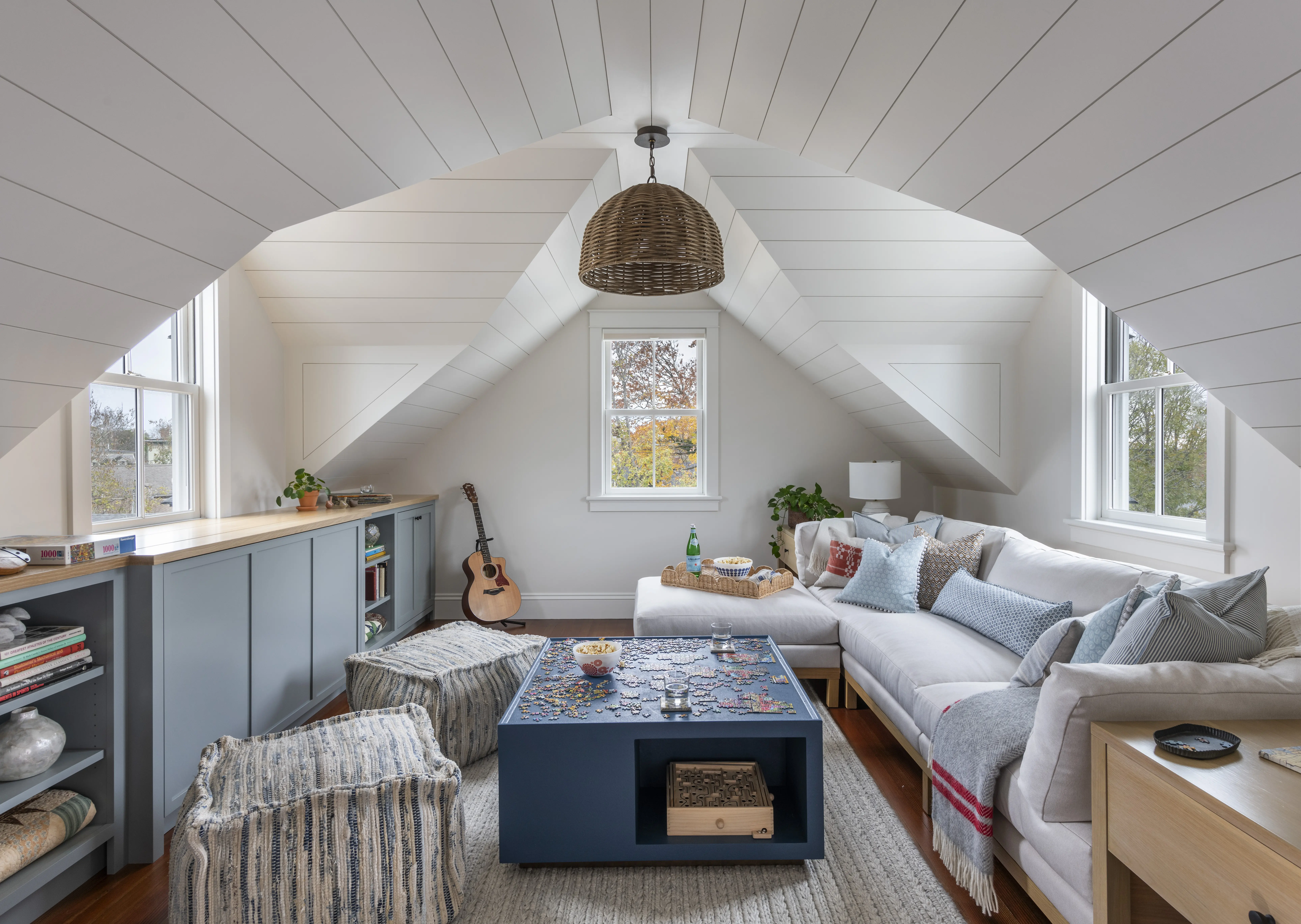 Attic family room with dormers and puzzle table and built ins designed by Taste Design
