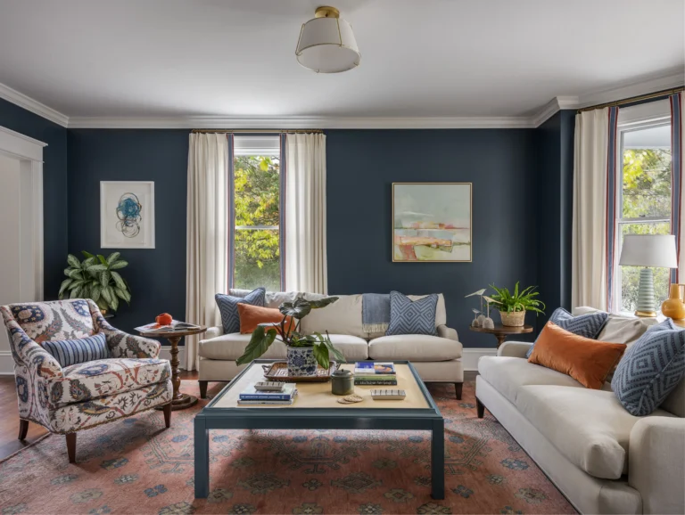 Eclectic Newport living room with blue walls and vintage rug