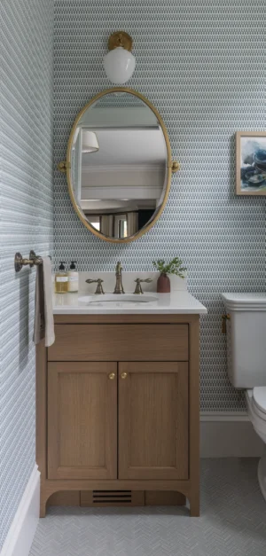 Power room renovation with blue and white wallpaper and brass accents