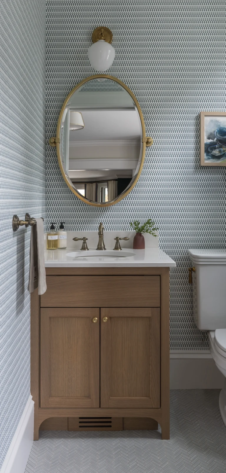 Power room renovation with blue and white wallpaper and brass accents