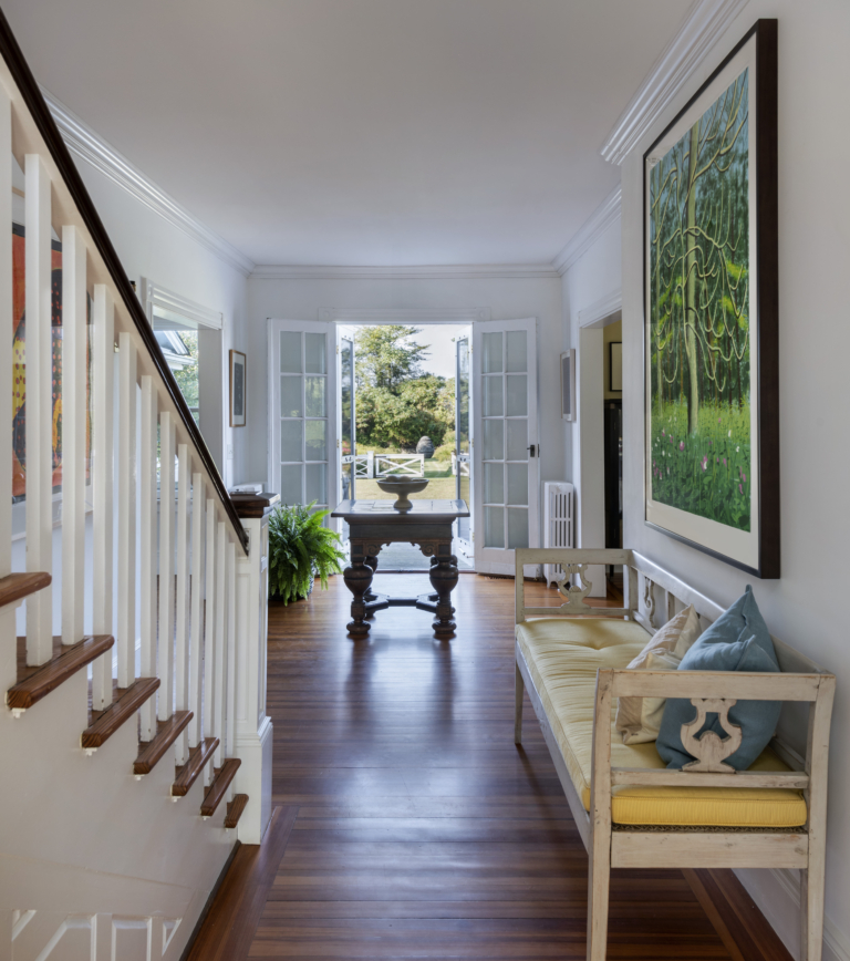 The foyer and staircase of a summer cottage in Rhode Island
