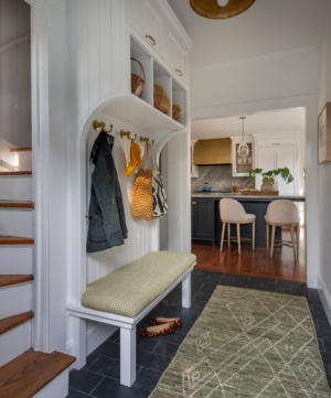 the side entryway and back staircase with a small mudroom in a summer cottage