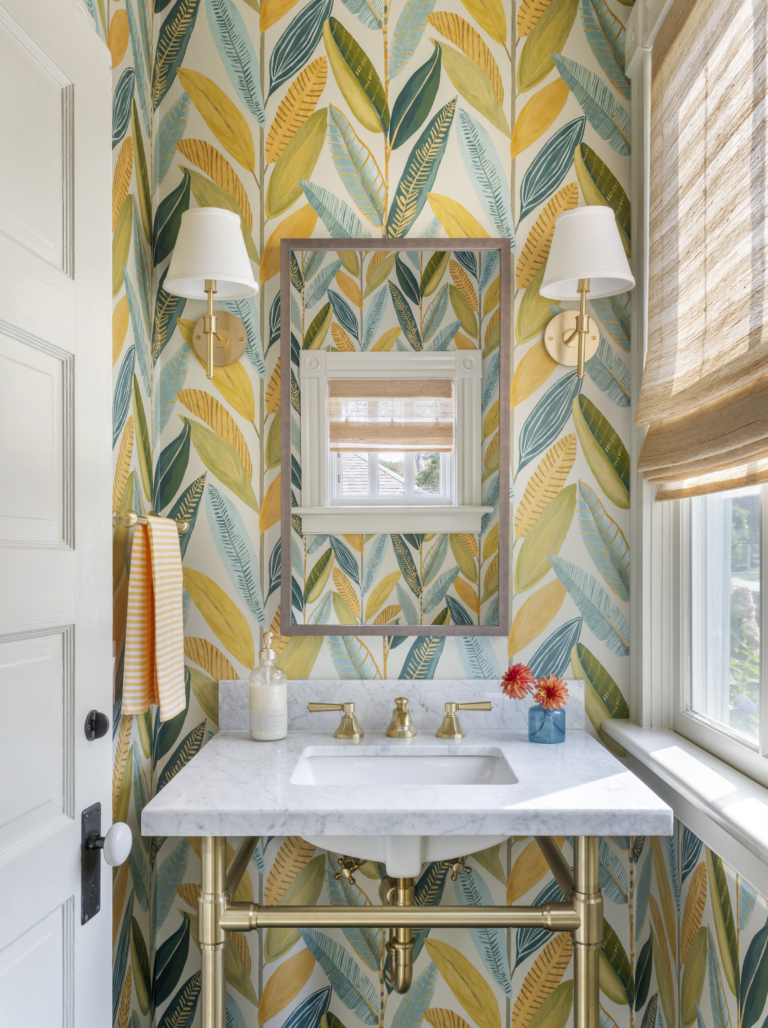 A powder room with yellow green and blue leaf wallpaper