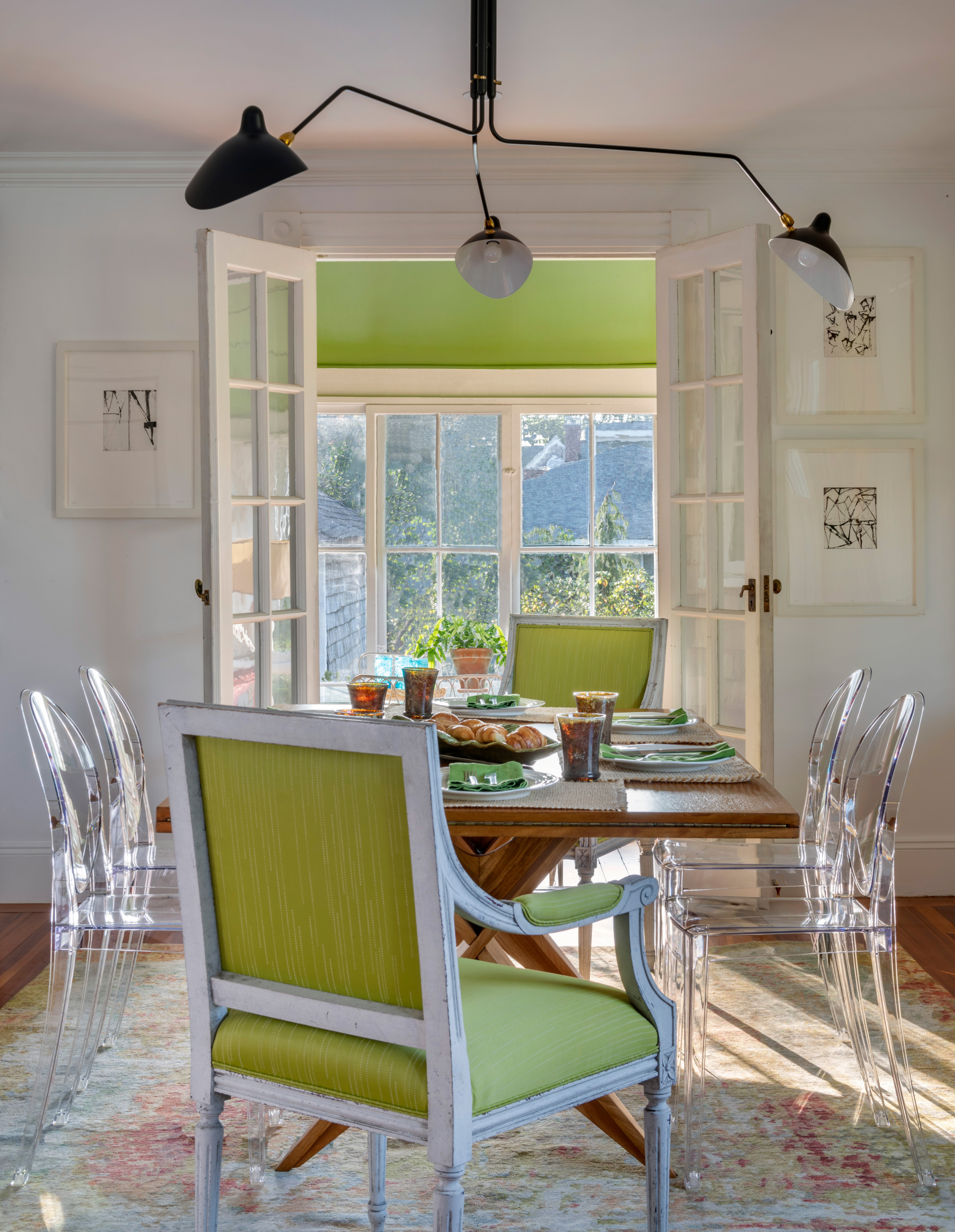 A dining room leading to a screened in porch