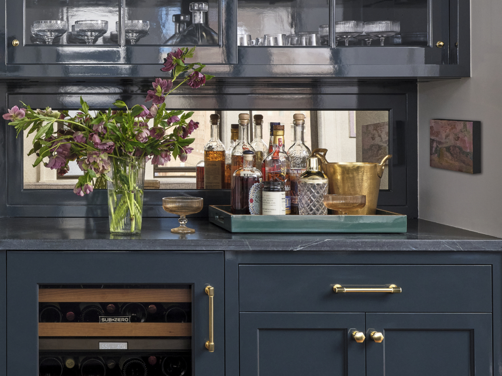 Styled home bar countertop with brass tray, glassware, and flowers in Upper West Side apartment renovation.