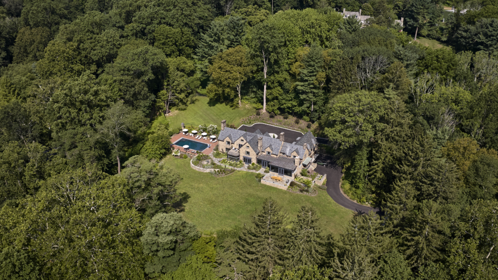Overhead view of an home with a pool in a wooded area