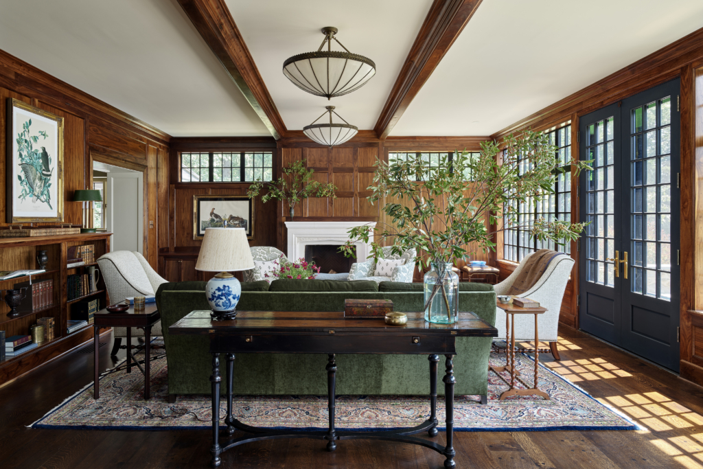 A wood-paneled living room with wooden ceiling beams
