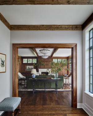 The doorway opening to a wood paneled living room
