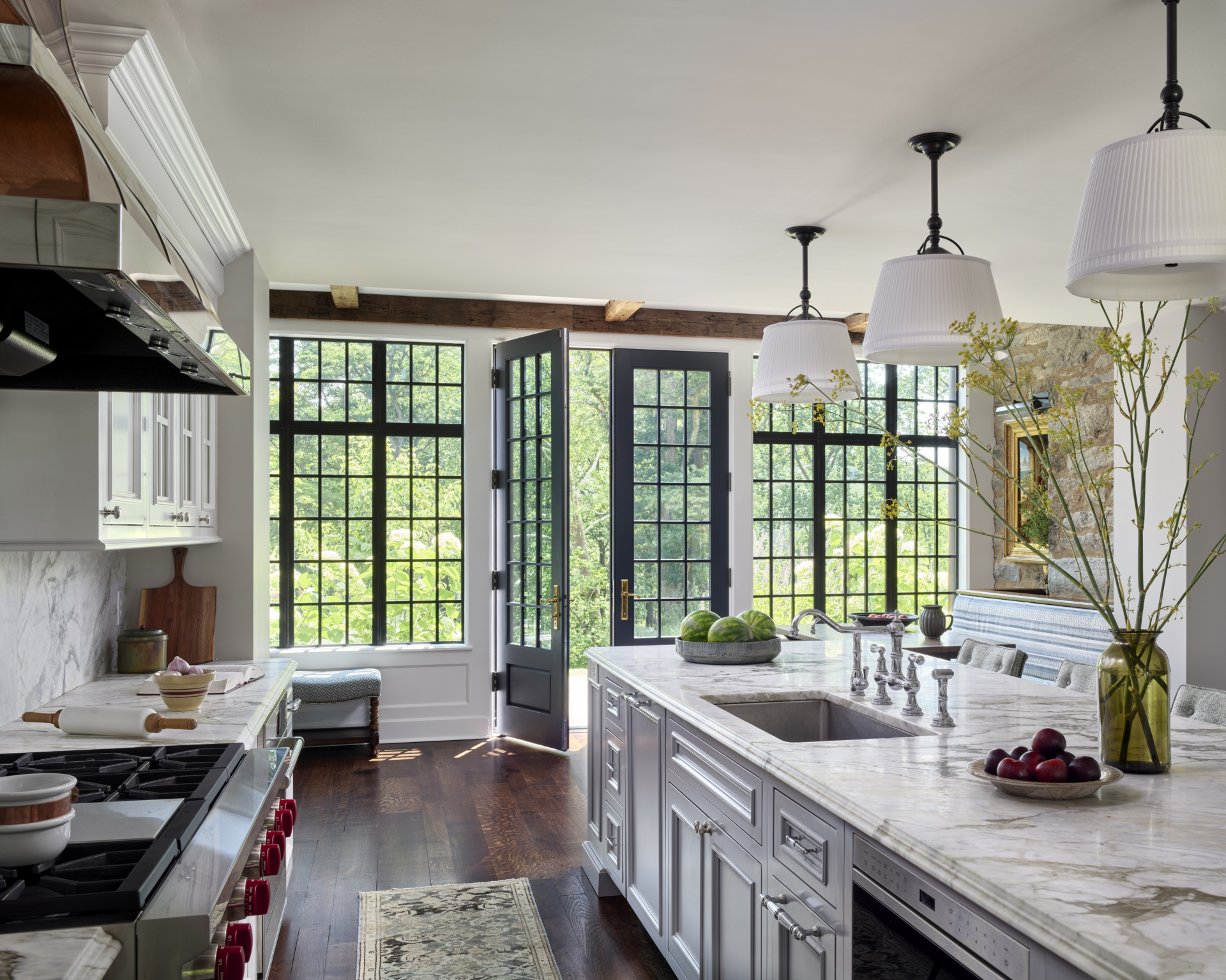 A kitchen island and leaded glass door and windows beyond