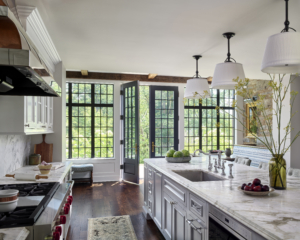 A kitchen island and leaded glass door and windows beyond